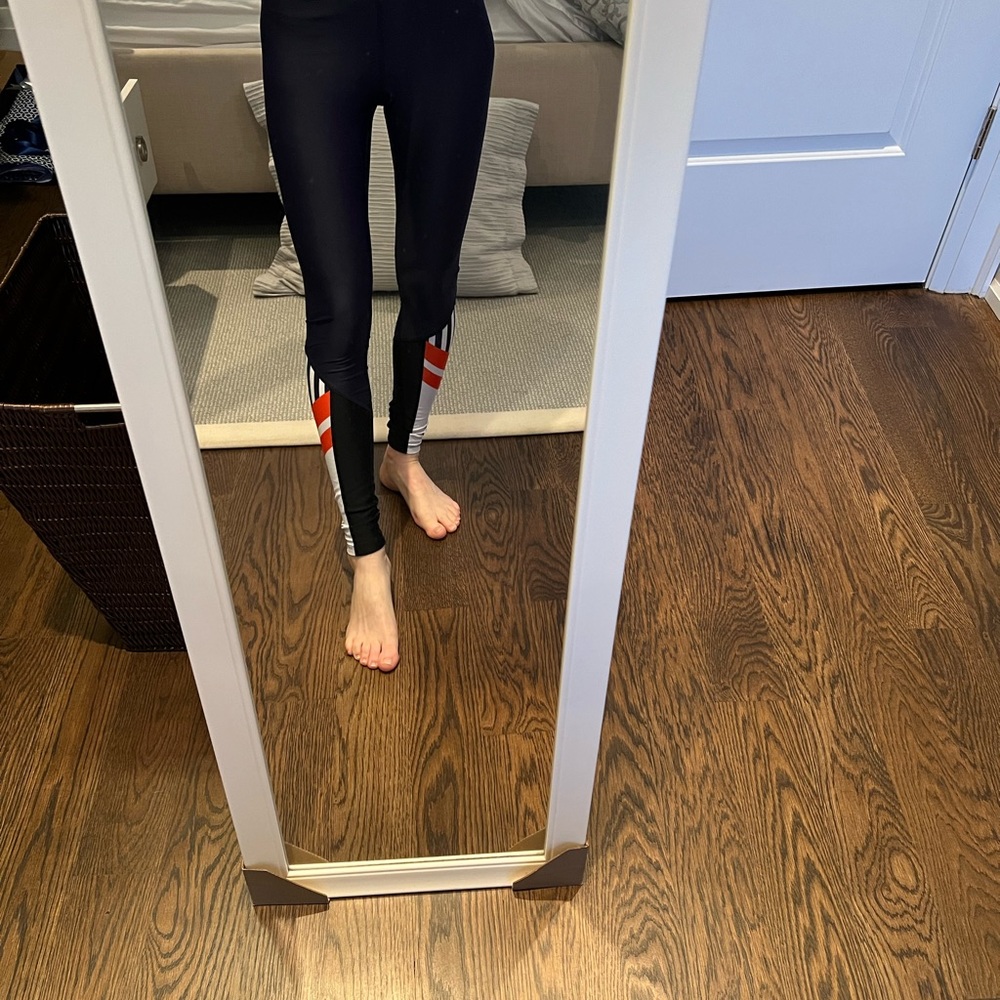 P.E. Nation navy blue workout leggings with thick black waistband